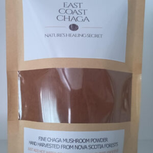 A small bag filled with dark, finely ground East Coast Chaga powder.