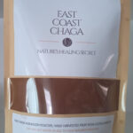 A 200 gram bag filled with dark, finely ground East Coast Chaga powder